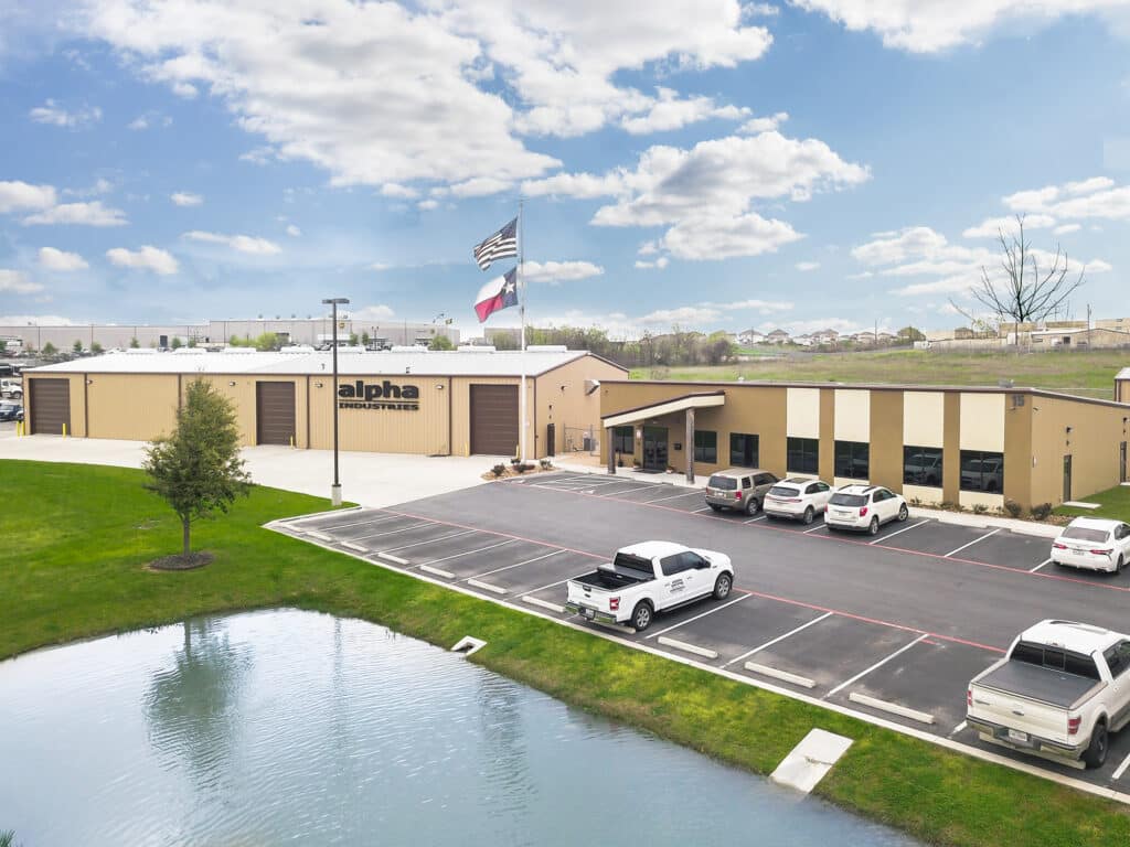 Completed commercial site work with paving and a detention pond at the Alpha Paving project by Aday & Associates