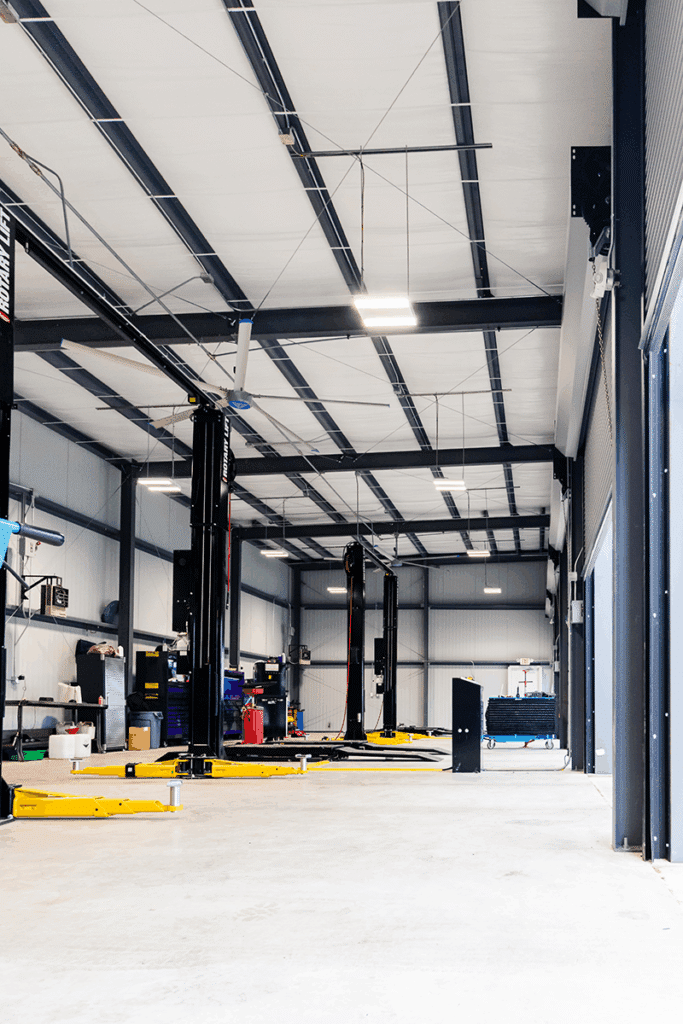 Interior of the Nyle Maxwell Taylor service building with vehicle lifts, built by Aday & Associates